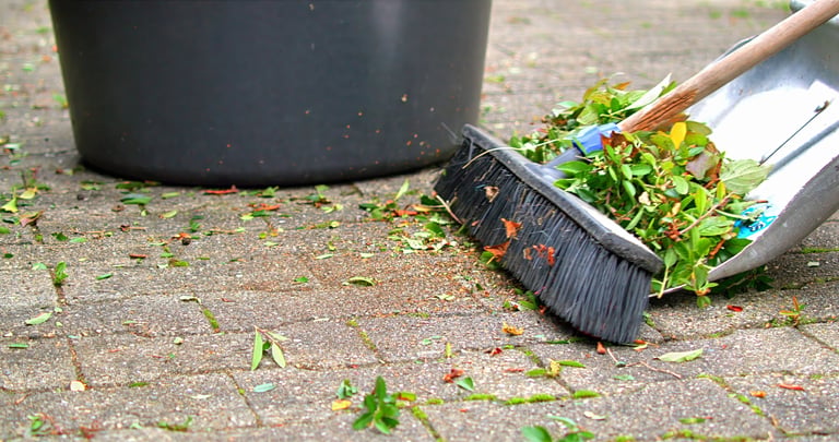 Broom And Dustpan Sweeping Brick Pavement
